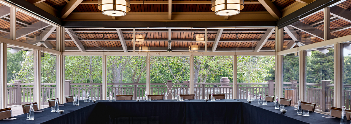 a table with chairs and a black tablecloth