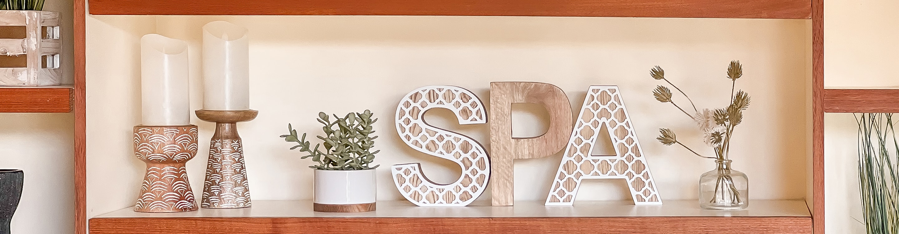 a shelf with vases and candles