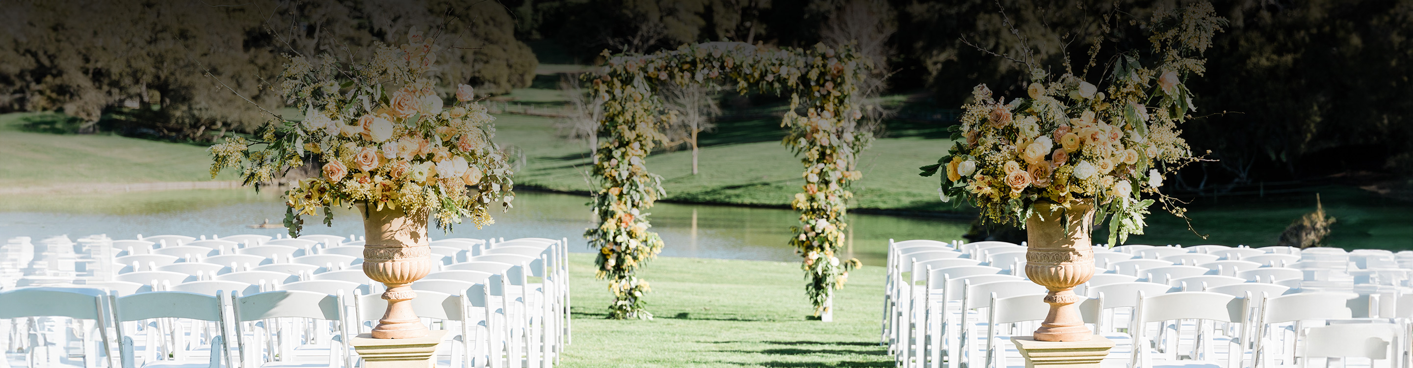 a wedding ceremony with chairs and flowers