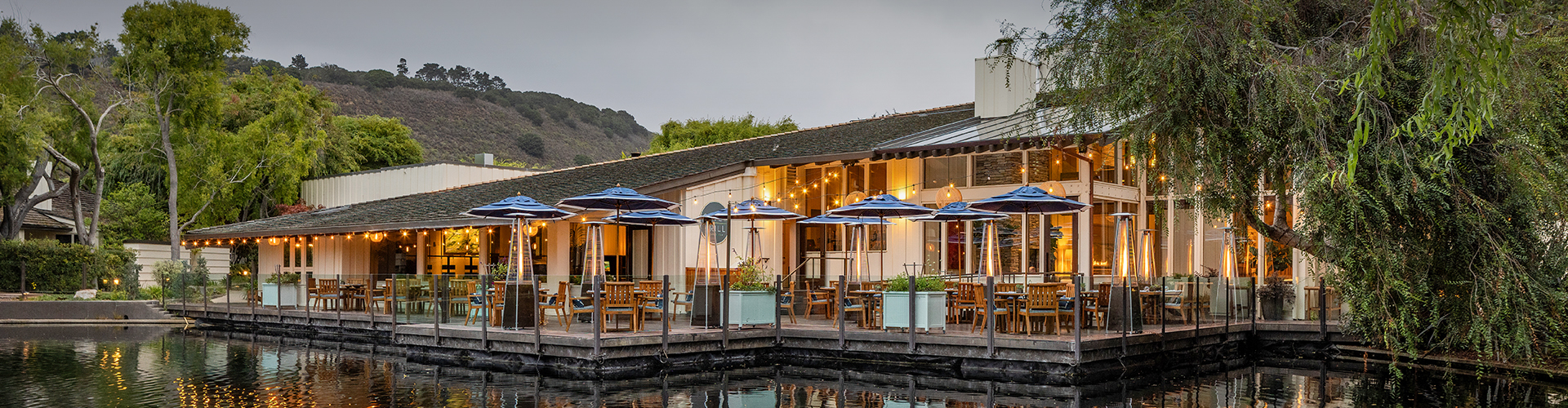 a building with a dock and umbrellas