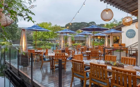 a patio with tables and umbrellas