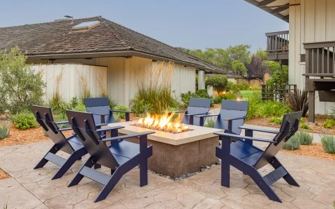 a fire pit with chairs around it