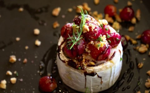 a plate of food with cranberries and nuts